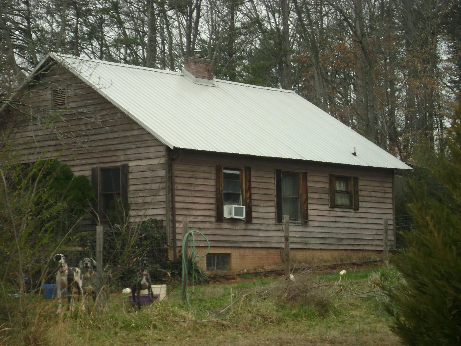 White metal roof on an old wood sided farmhouse, from a Metal Roof Installation job in Lavinia